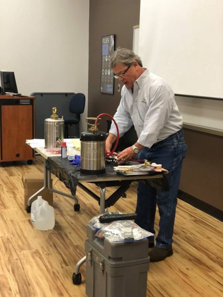 Michael Crowe of Univar demonstrates repair of a sprayer
